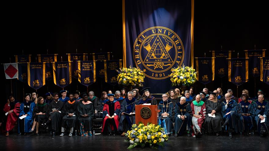 The stage at convocation with speakers, trustees and drexel banners